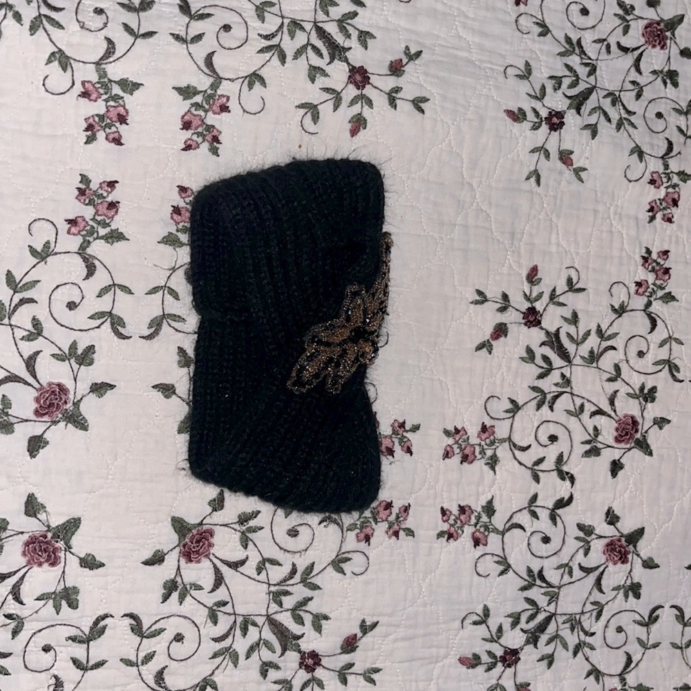 Black knitted headband with beaded design on front